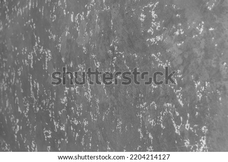 Grey plaster wall with abstract pattern stucco texture background surface.
