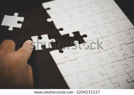 Business woman person hand with puzzle piece idea for strategy and solution. Closeup part of two white jigsaw connect together. Concept of join cooperation success teamwork-problem corporate team.