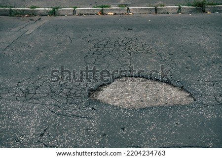 A pothole on asphalt road
