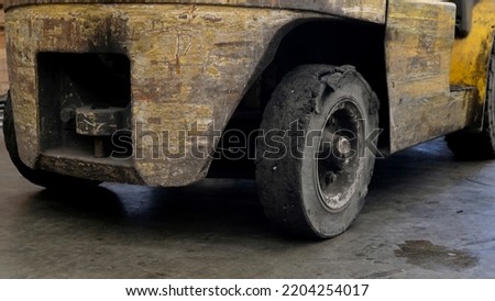 Forklift tires in the factory With torn tire condition and not safe to use. Broken car on the road with damaged tire and disk. closeup damaged 18 wheeler semi truck burst tires by highway street. Royalty-Free Stock Photo #2204254017