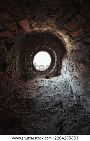 small round window in old castle 