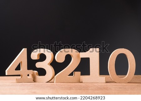 Wooden numbers of Four, Three, Two, One, and Zero on wooden table, countdown numbers Royalty-Free Stock Photo #2204268923