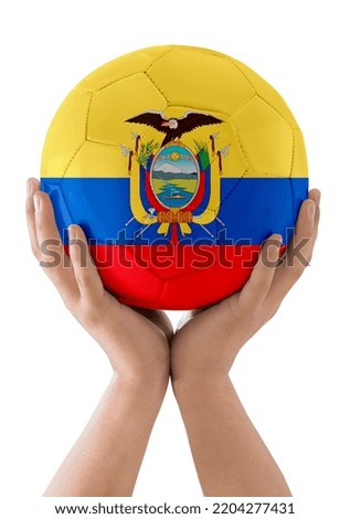 Man's hands raising a soccer ball with the flag of the Ecuador team as a trophy on a white background.