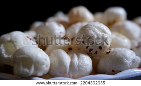 Side View Of White color popped Makhana or lotus seeds or fox nuts with background 