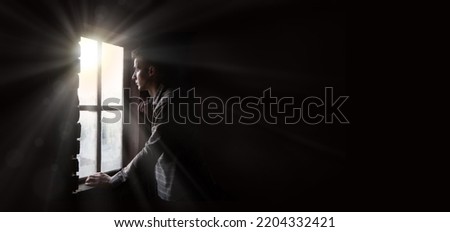 Old retro antique life young teen age frown boy guy face feel guilt light sky view. ancient lost tire guilty human cry ask belief god lord Christ love faith hand dark black room text space war concept Royalty-Free Stock Photo #2204332421