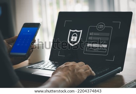 phishing scam, mobile phone hacker, or cyber scam concept. Password and login passcode in the smartphone. Online security threat and fraud. a scammer with cell phone and laptop. Bank account security. Royalty-Free Stock Photo #2204374843