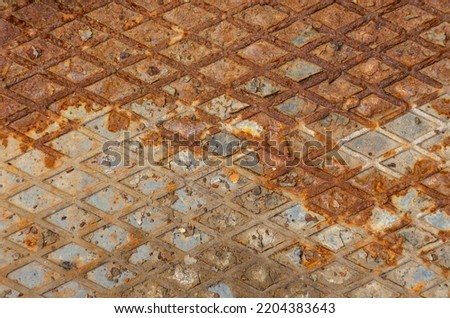 Industrial old rust metal steel sheet with rhombus shapes or checkered plates. Rusty metal background with two horizontal shadows