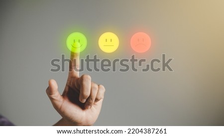 Business person are touching the virtual screen on happy Smiley face icon to give satisfaction in service. Customer service and Satisfaction concept, rating very impressed. customer service feedback. Royalty-Free Stock Photo #2204387261