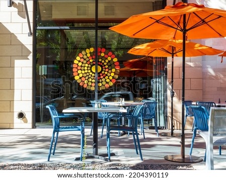 Empty cafe with tables and chairs. Street exterior of a restaurant in Cherry Creek district, Denver, Colorado