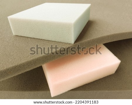 rectangular pieces of cream, gray and brown foam sponge neatly stacked. soft colored material with different thicknessl Royalty-Free Stock Photo #2204391183