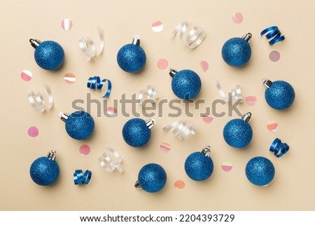 Christmas balls on color background, top view.