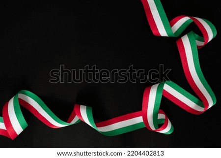 Ribbon with the colors of the Mexican flag on a black background, for Independence Day. High quality photo Royalty-Free Stock Photo #2204402813