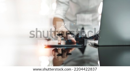 Man using digital tablet and laptop computer to webinar online, analyzing data. Business strategy. Abstract icon. Digital marketing.