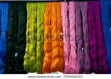 Material silk fiber and hand woven cotton thread dying with natural color hanging for show and sale in handmade crafts market event fair and studio workshop at Bitec Bangna in Bangkok, Thailand
