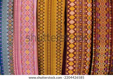 Material silk fabric and raw hand woven cotton with ancient pattern and antique design texture for show and sale in handmade crafts market fair and studio workshop at Bitec Bangna in Bangkok, Thailand