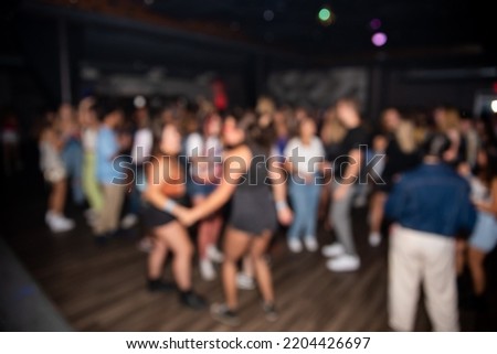 Blur image of a dance party at a club, background image. Party with People Blurred Background. Party and entertainment concept.