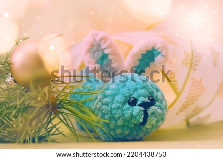New Year decorations. Golden lights. Christmas card with funny toy bunny. Happy new year 