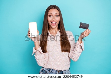 Photo of hooray young woman show telephone card wear white shirt isolated on blue color background