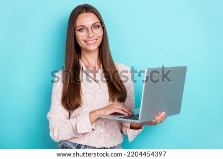 Photo of nice millennial woman work laptop wear shirt eyewear isolated on teal color background