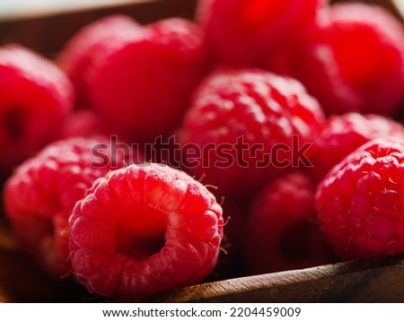 Light summer dessert - fresh juicy raspberries. Macro shot. Food background. Vitamins, antioxidants, healthy diet food. Healthy lifestyle.