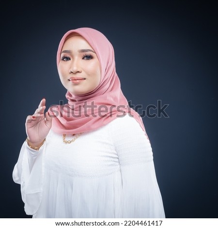 Portrait of a beautiful female Muslim model wearing hijab, a lifestyle apparel for Muslim women isolated. Modern hijab fashion concept.