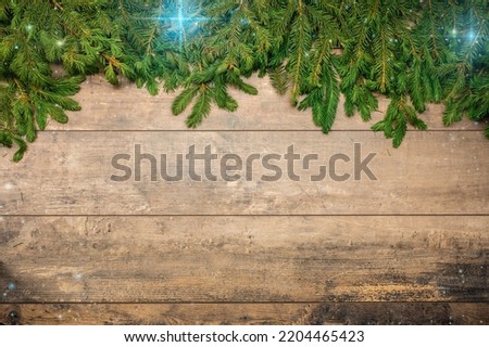 Christmas Background template. New Year background. Spruce branches on wooden table. Christmas concept. Frame made fir tree branches with stars on brown wooden table