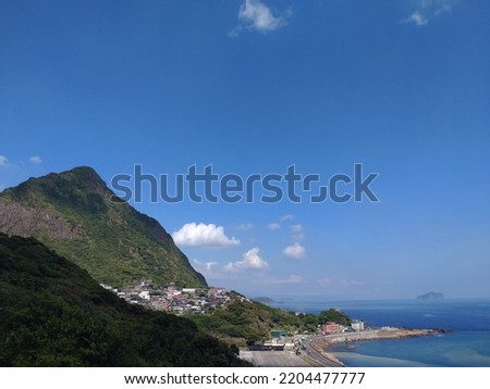 The view of the bay with the mountain and blue sky in Shuinandong nearby Jiufen in New Taipei City in Taiwan