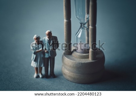 Hourglass and miniature senior couple