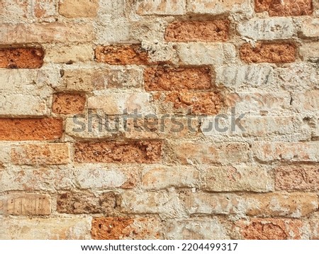  weathered orange brick wall. rough wall texture and background.ruins of object.