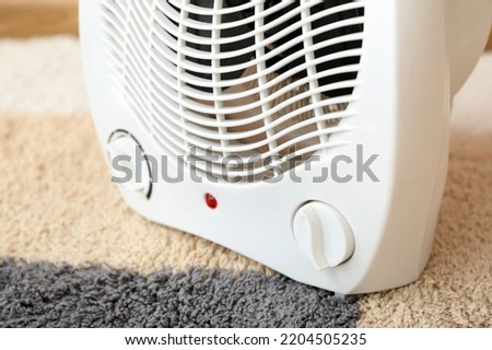 Electric fan heater on carpet, closeup