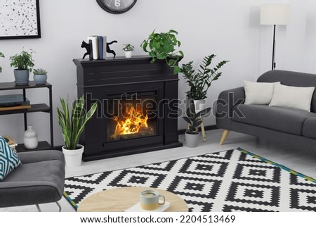 Stylish living room interior with fireplace and comfortable sofa