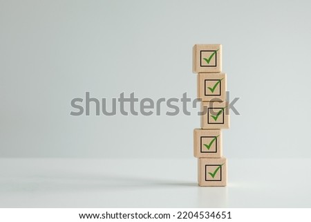 Checklist, Task list, Survey and assessment. Quality Control. Goal achievement and business success. Elections and Voting, Vote, to do list. Check mark icon on wooden blocks.