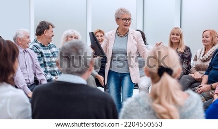 old lady teaches old people Royalty-Free Stock Photo #2204550553
