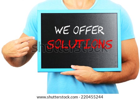 Man holding blackboard in hands and pointing the word WE OFFER SOLUTIONS