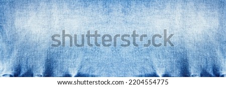 Banner Macro jeans textured background. Blue denim pattern top view and copy space. Template blank backdrop. Fashion cloth pattern mockup. Top view flat lay vintage trousers material. Selective focus Royalty-Free Stock Photo #2204554775