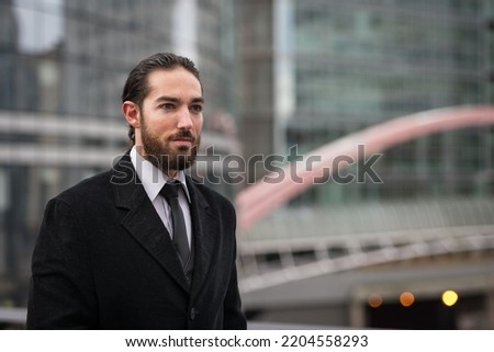 Confident young businessman portrait at the Defense District. Paris, France. 