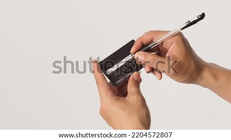 Hands is sign black credit card on white background