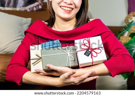 Happy woman in red sweater holding many boxes, Gift box in female hands. Holiday, gift, Holiday gift surprise, Merry Christmas and Happy new year season.