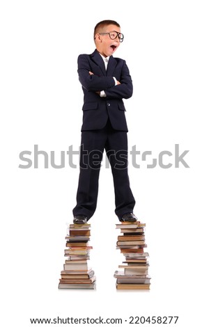 Schoolboy screaming on the huge stack of books isolated over white background