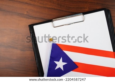 puerto rican official document mock up, place for text, tax on white sheet of paper on clipboard with flag puerto rico