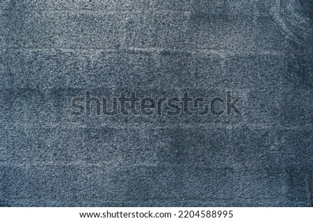 Vintage wall covered with gray decorative plaster, grungy background close-up, grunge antique texture.