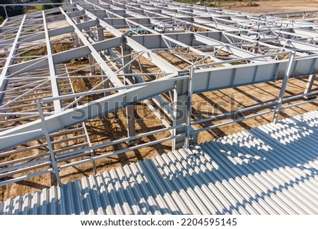Aerial view of warehouse construction from steel metal structure. Frame of modern hangar or factory construction site. Royalty-Free Stock Photo #2204595145