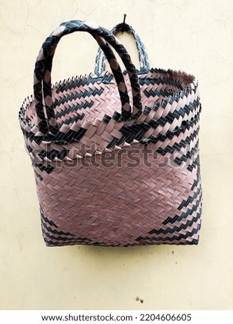 Photo of pink and black Woven Bag, taken from the close-up angle