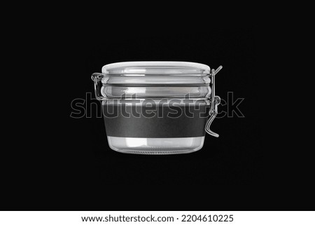 Airtight clear glass jar with label mockup isolated over dark background. 3d rendering.