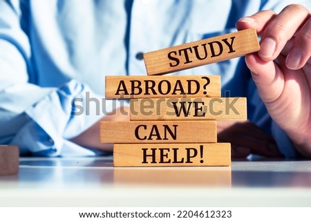 Wooden blocks with words 'Study Abroad? We Can Help!'.