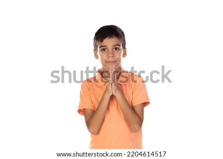 Lttle latin boy praying isolated on a white background  Royalty-Free Stock Photo #2204614517