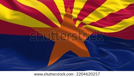 Close-up view of the Arizona state flag waving in the wind. Arizona is a state in the Western United States. Fabric textured background. Royalty-Free Stock Photo #2204620257