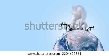 Beautiful planet earth with oil derricks, chimneys of factories with smoke extracting energy on a blue background. Pollution and global warming, concept. Energy and the global world. Save the planet Royalty-Free Stock Photo #2204622361
