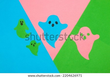 colorful paper ghosts on a colorful background, creative halloween concept, flat lay, paper craft