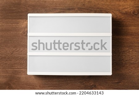Blank letter board on wooden table, top view. Mockup for design